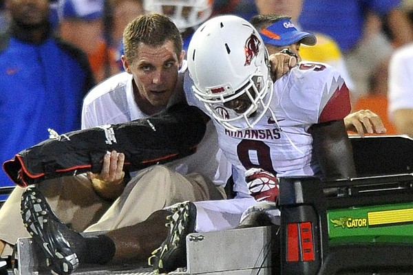 Arkansas cornerback Will Hines is carted off the field after injuring his arm Saturday at Ben Hill Griffin Stadium in Gainesville, Florida.