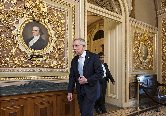 Senate Majority Leader Harry Reid leaves the Senate chamber after Saturday’s session.

