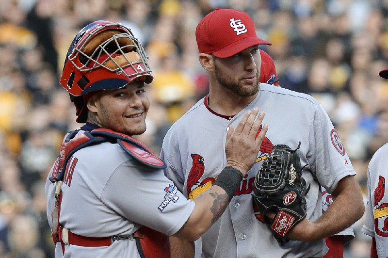 St. Louis Cardinals catcher Yadier Molina, left, pats starting pitcher Michael Wacha right before he was lifted from the baseball game in the eighth inning in Game 4 of a National League division series against the Pittsburgh Pirates on Monday, Oct. 7, 2013, in Pittsburgh. Wacha had a no-hitter going until Pirates' Pedro Alvarez hit a home run in that inning. (AP Photo/Don Wright)