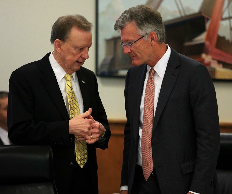 University of Arkansas at Little Rock Chancellor Joel Anderson (left) speaks with board of visitors member Jerry Jones on Tuesday before Anderson’s board presentation on a possible technology park site next to the campus. 