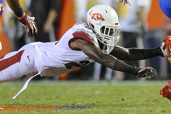 Arkansas defender Carroll Washington dives after Florida punt returner Loucheiz Purifoy as he runs back a punt in the 4th quarter of Saturday night's game at Ben Hill Griffin Stadium in Gainesville, Florida.
