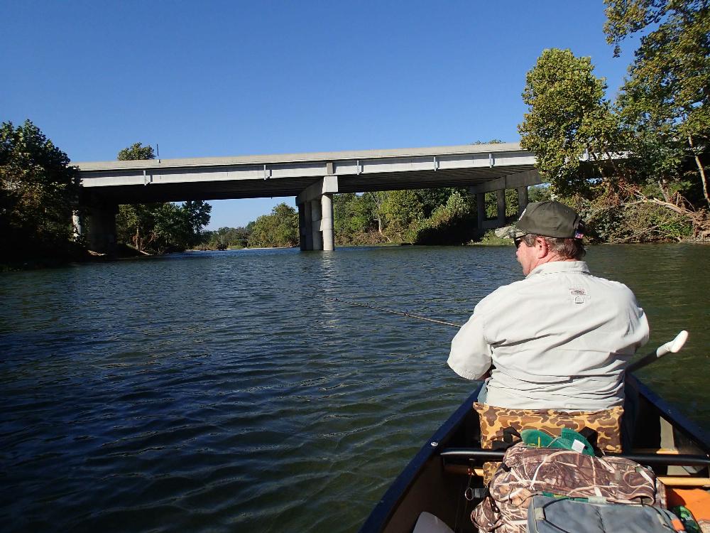 Duncan fishes his way toward the U.S. 71 bridge over the Elk River.