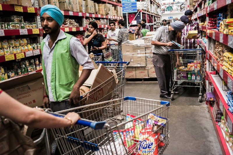 Customers shop last year at a Bharti Walmart Private Limited in Zirakpur, India. Wal-Mart Stores Inc. and Bharti Enterprises announced Wednesday that they have divvied up their ownership in different types of stores across India. 