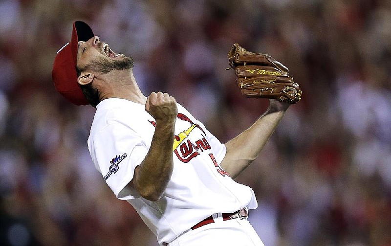 St. Louis pitcher Adam Wainwright celebrates after throwing a complete game, giving up 8 hits, 1 run, 1 walk and striking out 6 as the Cardinals rallied from a game down to defeat Pittsburgh and win the National League division series with a 6-1 victory Wednesday night in St. Louis. The National League Championship Series against Los Angeles begins Friday in St. Louis. 