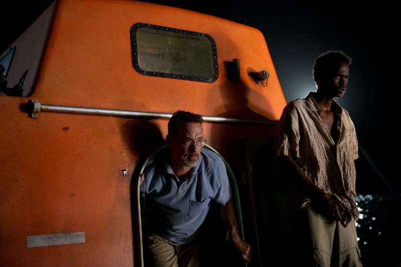 Capt. Rich Phillips (Tom Hanks) is held hostage by a group of Somali pirates including Bilal (Barkhad Abdirahman) in Paul Greengrass’ Captain Phillips. 