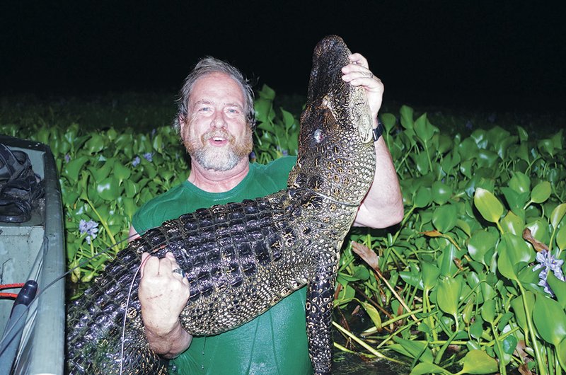 Keith Sutton poses with the 7 1/2-foot alligator he killed in the Arkansas River on Sept. 27. This year’s season, Arkansas’ seventh, ran Sept. 20-22 and Sept. 27-29. Hunters killed a total of 44 alligators statewide.