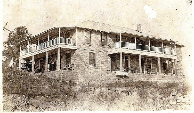 This is an early photo of the River View Hotel. In later years, the open porches on the left side were enclosed as sunrooms. The sign in front still reads “Sanders Hotel.”