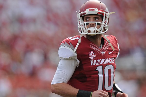 Arkansas quarterback Brandon Allen walks off the field after the Razorbacks failed to convert on third down during the second quarter of play Saturday, Oct. 12, 2013, at Razorback Stadium in Fayetteville.