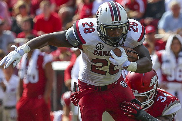 South Carolina running back Mike Davis (28) pulls Arkansas linebacker Braylon Mitchell in the third quarter during their game Saturday, Oct. 12, 2013 in Fayetteville. South Carolina won 52-7.