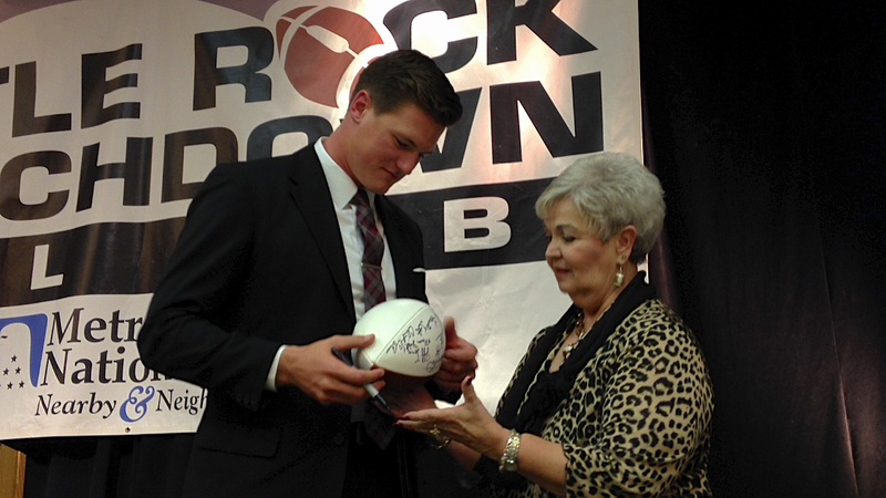 Former Arkansas quarterback Mitch Mustain signs autographs after his address of the Little Rock Touchdown Club on Monday afternoon. 