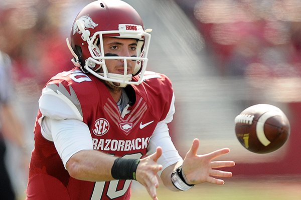 Arkansas' Brandon Allen pitches to the backfield Saturday, Oct. 12, 2013, during the third quarter of the game against South Carolina at Donald W. Reynolds Razorback Stadium in Fayetteville. The Razorbacks lost to the Gamecocks, 52-7.