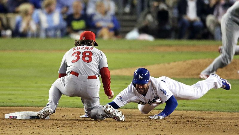 St. Louis shortstop Pete Kozma makes the tag on Los Angeles’ Nick Punto as he is picked off second base by reliever Carlos Martinez in the seventh inning of the Cardinals 4-2 victory in Game 4 of the National League Championship Series on Tuesday night. 