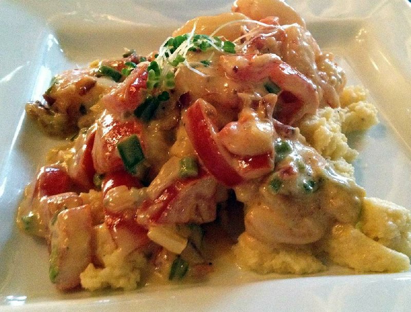 The Shrimp and Grits at Cellar 220 are tossed with bacon, tomatoes, green onions, white wine and a shot of rosemary cream. 
