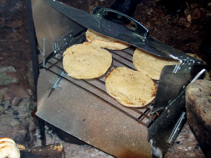 With a reflector oven, the camp chef can quickly bake almost any type of food, from English muffins (pictured here) to cakes, pizzas and cookies.