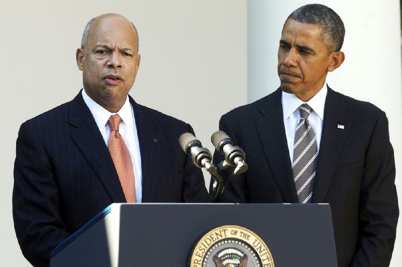 President Barack Obama stands with Jeh Johnson, his choice for the next Homeland Security Secretary, in the Rose Garden at the White House in Washington, Friday, Oct. 18, 2013. Johnson was general counsel at the Defense Department during the wars in Iraq and Afghanistan. (AP Photo/Charles Dharapak)