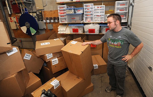 Nick Amburgey of Fayetteville shows where he works Thursday to unpack and sort clothing items at Fayetteville’s Old Navy store. 