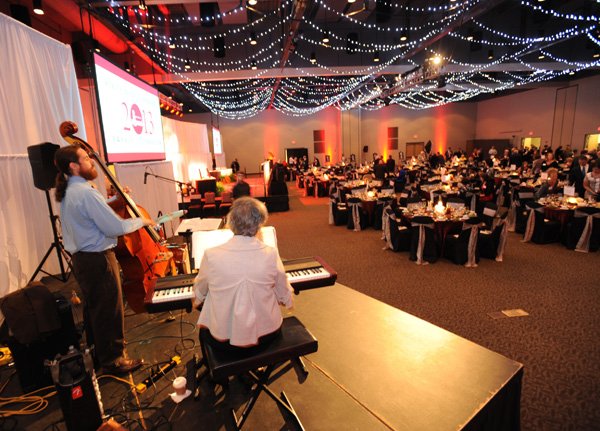 Participants in the annual University of Arkansas Alumni Awards Banquet speak Oct. 11 before the start of the program at the Fayetteville Town Center. Voters Nov. 12 will decide whether to issue $11.9 million in bonds to improve the Walton Arts Center, build a regional park and pay off the debt associated with the Town Center.
HOTEL, MOTEL RESTAURANT TAX 