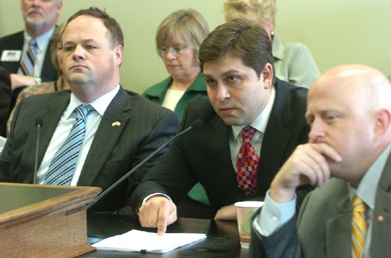 State Sen. Jonathan Dismang (center), a sponsor of the legislation authorizing the expansion of Medicaid under the private option, said enrollment would likely be higher were it not for problems that have plagued healthcare.gov.