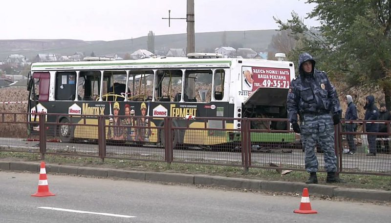 Experts and officials examine the wreckage of a bus Tuesday in Volgograd, Russia, in this image made from video. A female suicide bomber blew herself up on the city bus Monday, killing six people. 