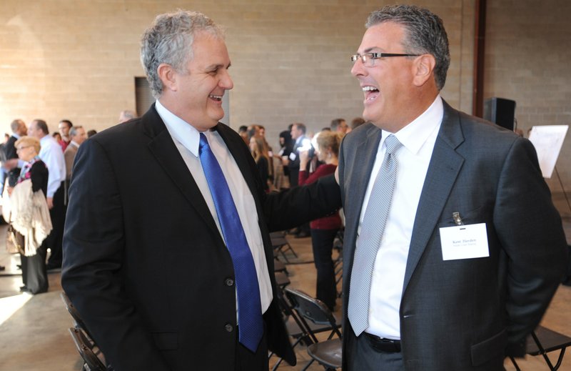 Springdale Mayor Doug Sprouse, left, laughs with Kent Hayden, CEO of South Coast Baking, Wednesday during the official announcement that South Coast, a bakery company based in California, is establishing a facility in Springdale.