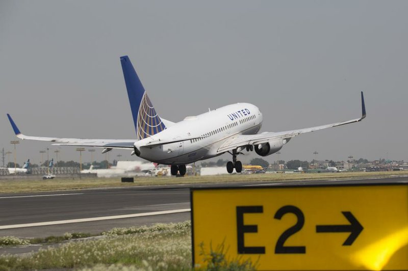 A Boeing 737-700 jet, operated by United Continental Holdings Inc., lands at Benito Juarez International Airport in Mexico City, earlier this month. Boeing said third-quarter revenue rose 11 percent to $22.1 billion. 