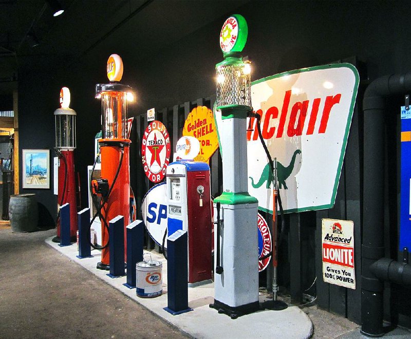 A display of old-time filling-station pumps adds a nostalgic touch inside the Arkansas Museum of Natural Resources near Smackover. 
