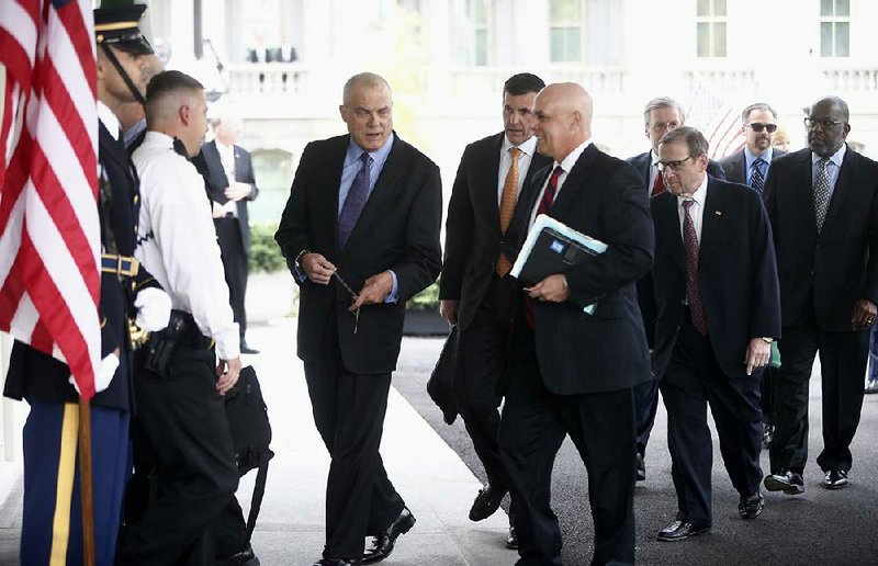 Mark Bertolini of Aetna (from left), Bruce Broussard of Humana, Patrick Geraghty of Blue Cross and Blue Shield of Florida and other health-care executives arrive Wednesday at the White House for talks about the Patient Protection and Affordable Care Act. 