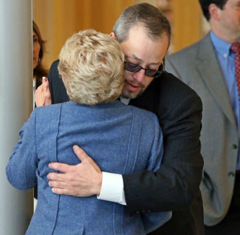 Gardner Trask, chairman of the Danvers Board of Selectmen, embraces an unidentified woman Wednesday after a news conference in Danvers, Mass., announcing the death of Danvers High School teacher Colleen Ritzer. A 14-year-old student was charged in Ritzer’s death. 