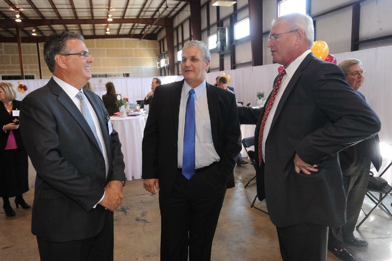 Kent Hayden (left) with South Coast Baking Co. speaks Wednesday with Springdale Mayor Doug Sprouse and Perry Webb with the Springdale Chamber of Commerce after the company announced that it was locating a plant in the state. 
