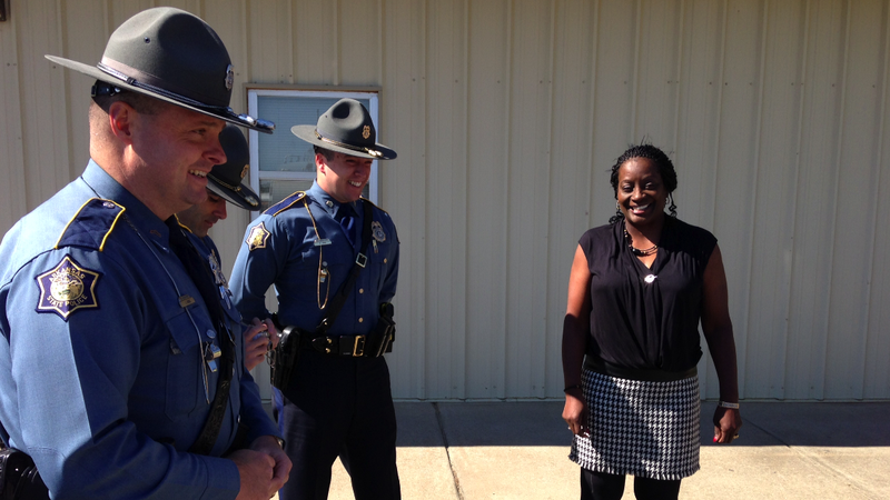 Jacksonville school bus driver Sheila Hart, who on Wednesday was honored for her actions after a man hijacked the school bus she was operating on Oct. 17, speaks with Arkansas State Police troopers prior to the ceremony. 