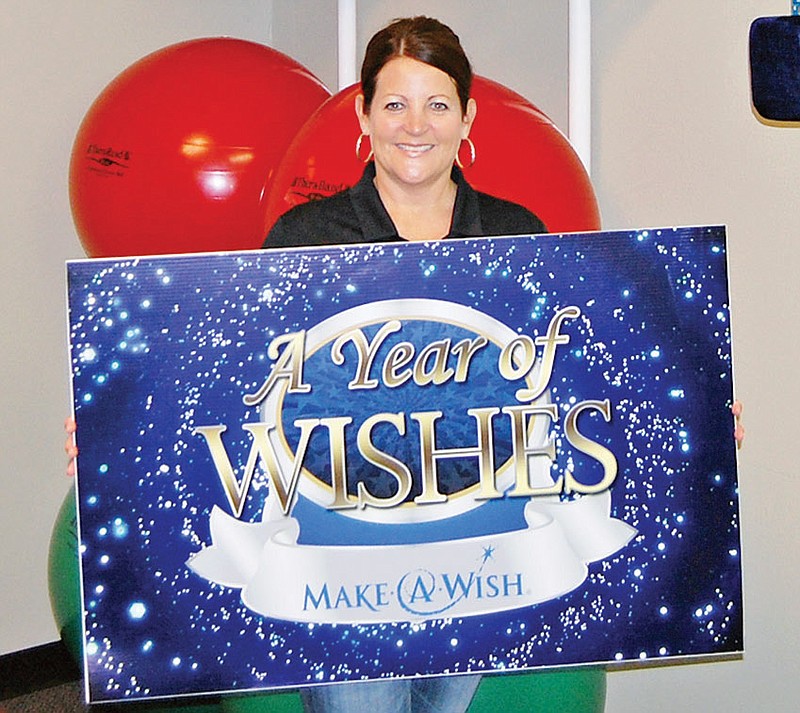 Dr. Melanie Spann of Lifeline Chiropractic in Bryant holds a sign from her 2013 campaign for the Make-A-Wish Foundation. Each of the stars above her head represents one new patient. A portion of the fee for a patient’s first visit is contributed to Make-A-Wish to make a dream come true for a local child. Spann selects a new philanthropic project each year.