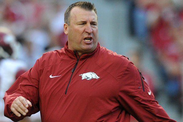 Arkansas coach Bret Bielema works with his players before the start of Saturday's game against Alabama at Bryant-Denny Stadium in Tuscaloosa, Alabama.