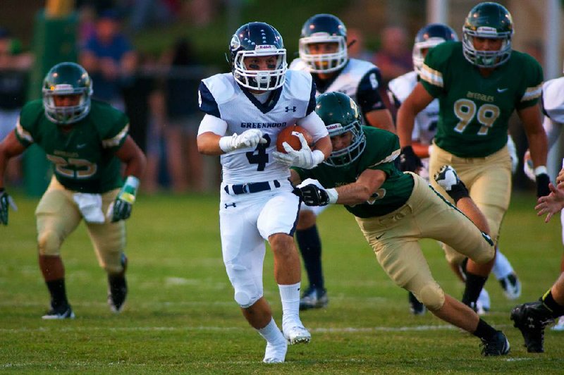 #4 Hoyt Smith of Greenwood cuts up field during the first half on Friday.