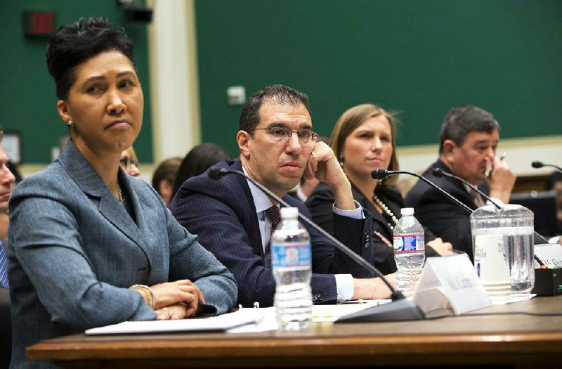 From left, Cheryl Campbell, senior vice president of CGI Federal; Andrew Slavitt, group executive vice president for Optum/QSSI; Lynn Spellecy, corporate counsel for Equifax Workforce Solutions; and John Lau, program director for Serco, listen to questioning on Capitol Hill in Washington, Thursday, Oct. 24, 2013, during a House Energy and Commerce Committee hearing with contractors that built the federal government's health care websites. The contractors responsible for building the troubled Healthcare.gov website say it was the government's responsibility _ not theirs _ to test it and make sure it worked. (AP Photo/ Evan Vucci)