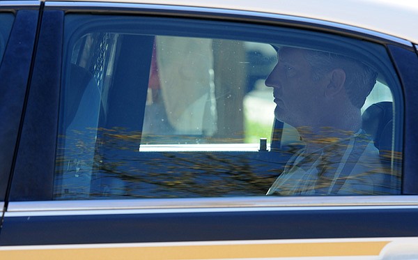 Barry Gebhart, Fayetteville High School athletic director, sits in the back of a Benton County Sheriff's vehicle Wednesday, Oct. 23, 2013, after his bond hearing at the Benton County Courthouse Annex in Bentonville. Gebhart's bond was set at $75,000 while his arraignment hearing was scheduled for Dec. 2.