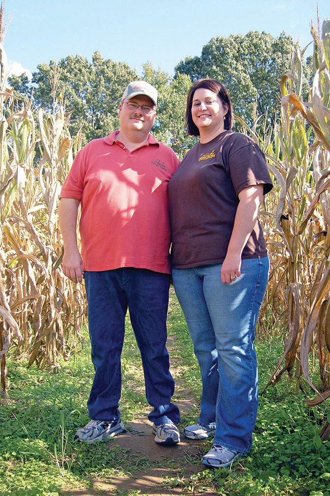 Kevin and Rebekah Hicks stand in their corn maze — an annual tradition available for visitors to Hicks Family Farms. This year’s design was created to honor the memory of family members who have died.