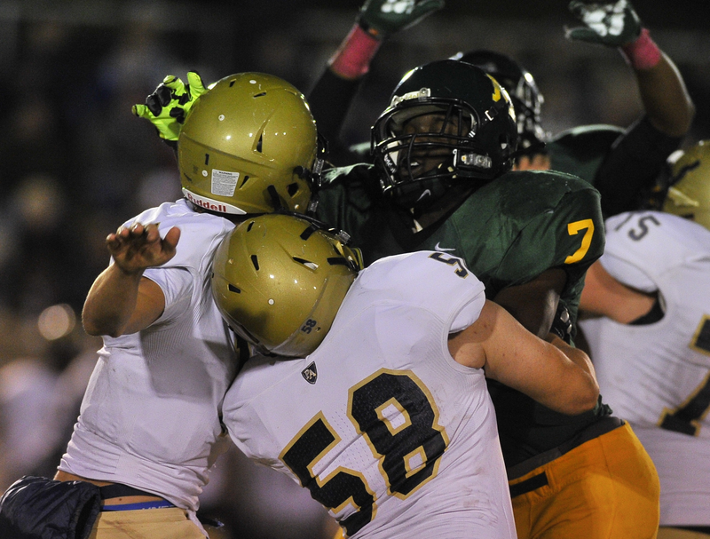 Mills linebacker De'Mario Allen (7) pressures Pulaski Academy quarterback Will Hefley (left) during the 2nd quarter of Friday night's game against PA in Little Rock.