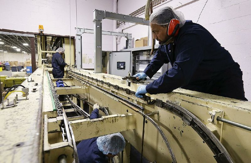 Jorge Farber, owner of Madelaine Chocolate in the Queens borough of New York, stands next to pallets of parts needed to repair a machine at his factory that was damaged during superstorm Sandy. 