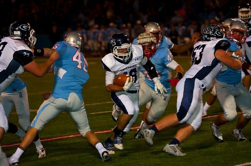 Greenwood’s Austin Gaines follows the blocking of Korban Waldemar (63) for a fi rst-half touchdown in the Bulldogs’ 45-42 victory over Fort Smith Southside on Friday at Jim Rowland Stadium in Fort Smith. It was the Bulldogs’ 46th consecutive victory.

