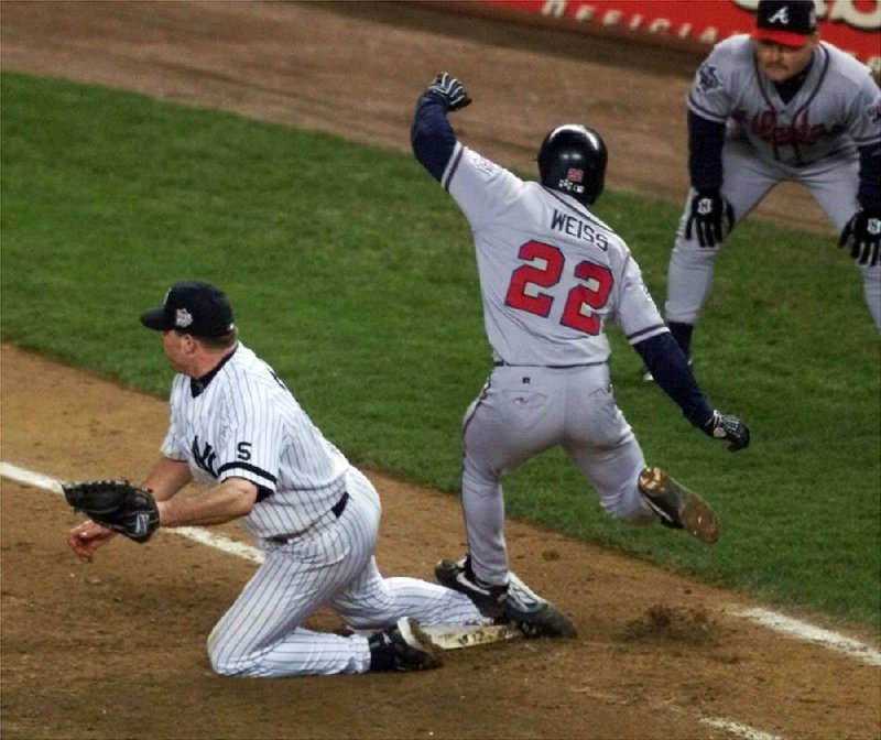 Atlanta Braves' Walt Weiss steps on New York Yankees pitcher Roger Clemens in the eigth inning as Clemens went over to cover the bag in game 4 of the World Series in New York, Wednesday, Oct. 27, 1999. Weiss reached first safely on an infield single. (AP Photo/Elise Amendola)