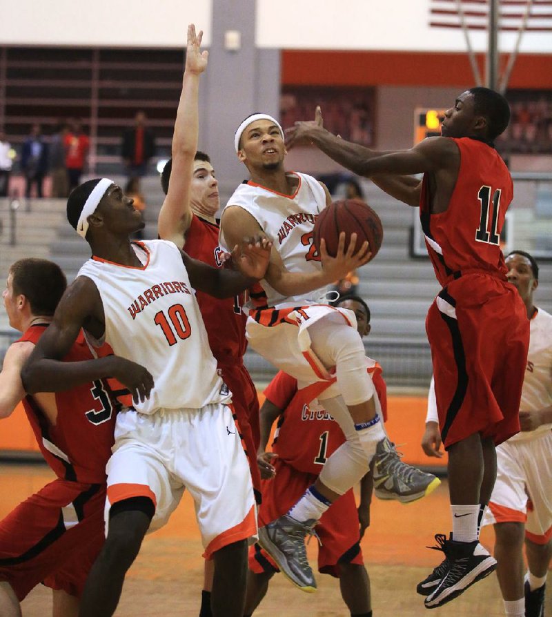 Arkansas Democrat-Gazette/RICK MCFARLAND --02/15/13-- Hall's Greg Easter drives in the lane for a shot on Russellville defenders' Jalen Curtis (11) and Dakota Young (left) in their game at Hall in Little Rock Friday night. Hall's Bobby Portis (10) is screening for him.