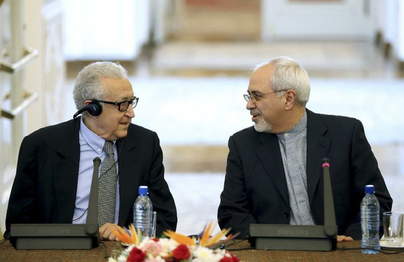 Iranian Foreign Minister Mohammad Javad Zarif (right) talks with United Nations-Arab League envoy for Syria Lakhdar Brahimi before a news conference Saturday in Tehran. 