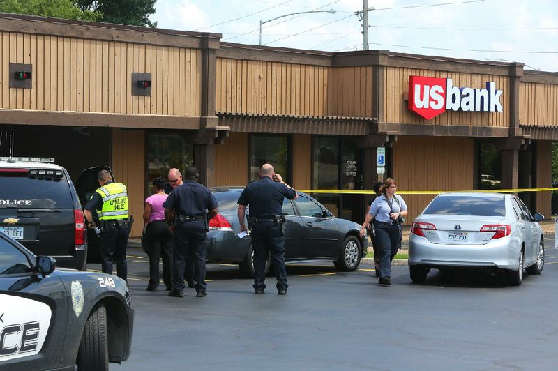 Little Rock police investigate a robbery at the U.S. Bank on Rodney Parham Road in June. The summer saw a 26 percent increase in robberies in Little Rock over the same period in 2012. 