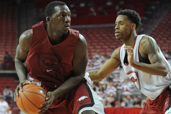 Arkansas forward Alandise Harris, left, looks to drive past guard Anthlon Bell during the second half of play in the Red-White game Sunday, Oct. 27, 2013, in Bud Walton Arena in Fayetteville.