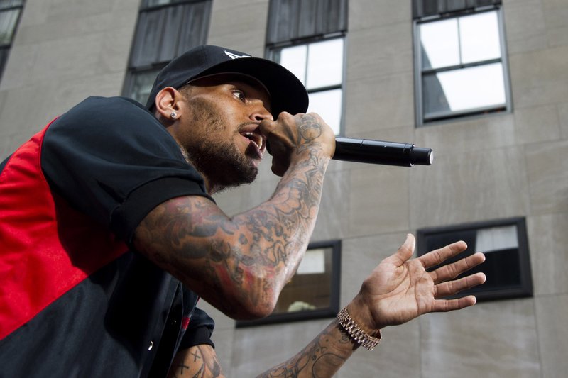 In a Friday, Aug. 30, 2013 file photo, Chris Brown performs on NBC's "Today" show in New York. R&B singer Chris Brown was arrested early Sunday, Oct. 27, 2013 in Washington after a fight broke out near the W Hotel near the White House. District of Columbia Police spokesman Officer Paul Metcalf says 24-year-old Brown was arrested and charged with felony assault. Metcalf says 35-year-old Chris Hollosy also was arrested on felony assault charges after the incident. (Photo by Charles Sykes/Invision/AP, File)