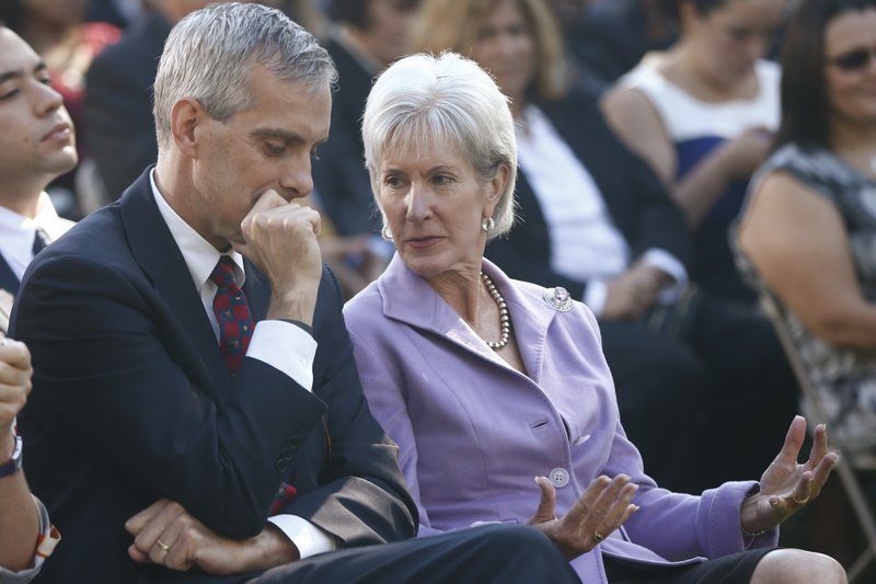 Health and Human Services Secretary Kathleen Sebelius, right, is seated with White House Chief of Staff Denis McDonough as President Barack Obama speaks during an event in the Rose Garden of the White House on the initial rollout of the health care overhaul on Monday, Oct. 21, 2013 in Washington. Obama acknowledged that the widespread problems with his health care law's rollout are unacceptable, as the administration scrambles to fix the cascade of computer issues. (AP Photo/Charles Dharapak)