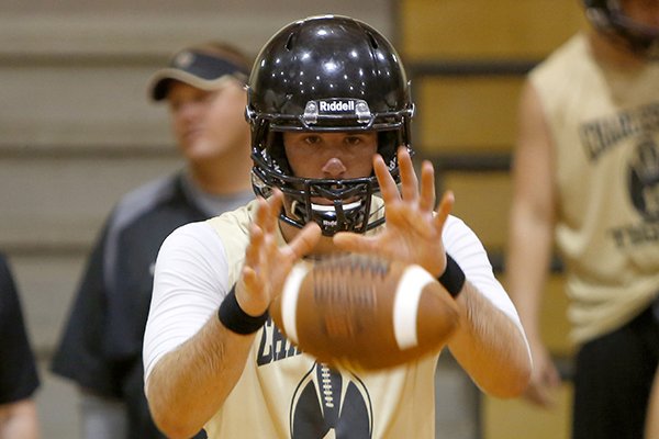 Charleston quarterback Ty Storey takes a snap during an Aug. 9, 2013 practice. 