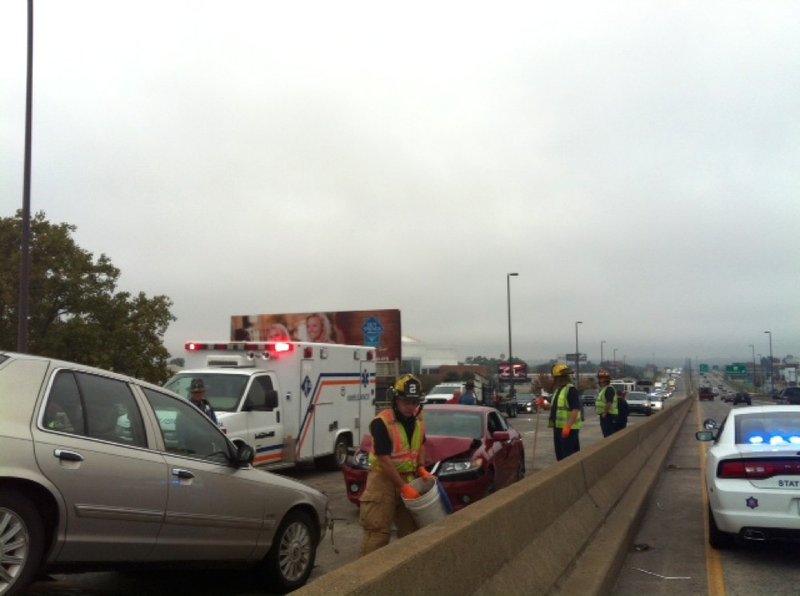 Authorities work the scene Monday, Oct. 28, 2013, of a four-vehicle wreck on the Interstate 30 bridge between Little Rock and North Little Rock.