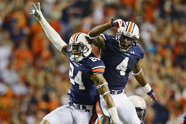 Auburn's Ryan Smith (24) and Quan Bray (4) celerate Smith's interception against Mississippi during the second half of an NCAA college football game on Saturday, Oct. 5, 2013 in Auburn, Ala. Auburn won 30-22. (AP Photo/Todd J. Van Emst)