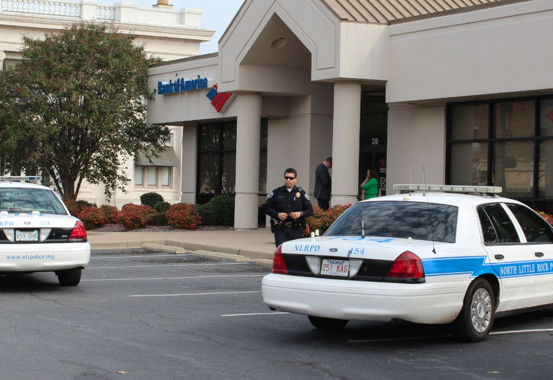 Police work Tuesday, Oct. 29, 2013, the scene of a robbery at a Bank of America branch in downtown North Little Rock.